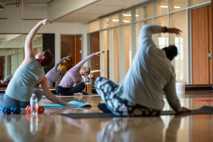 yoga students practicing yoga in studio.