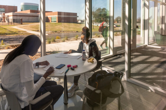 Students studying in large atrium space