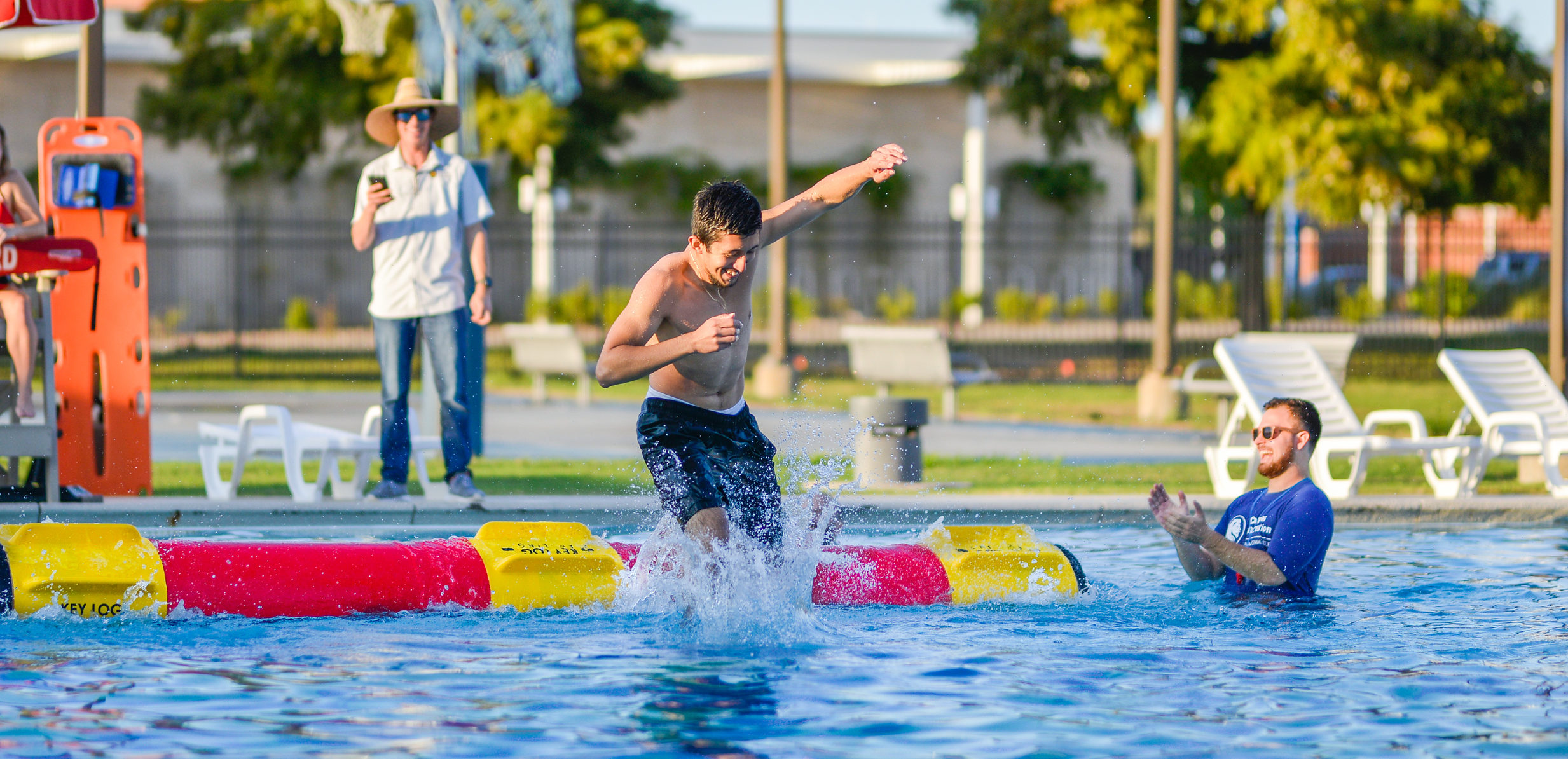 A student during a log rolling competition at the Campus Recreation pool.