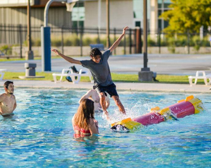 Four people having fun at the pool at the Morris Recreation Center.