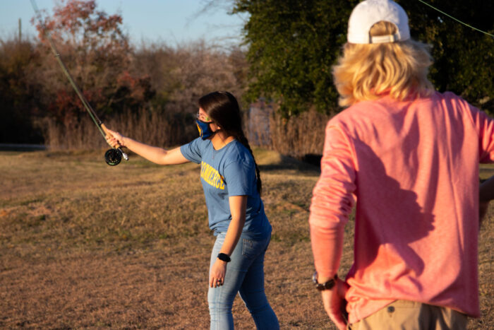 TAMUC student fishing.