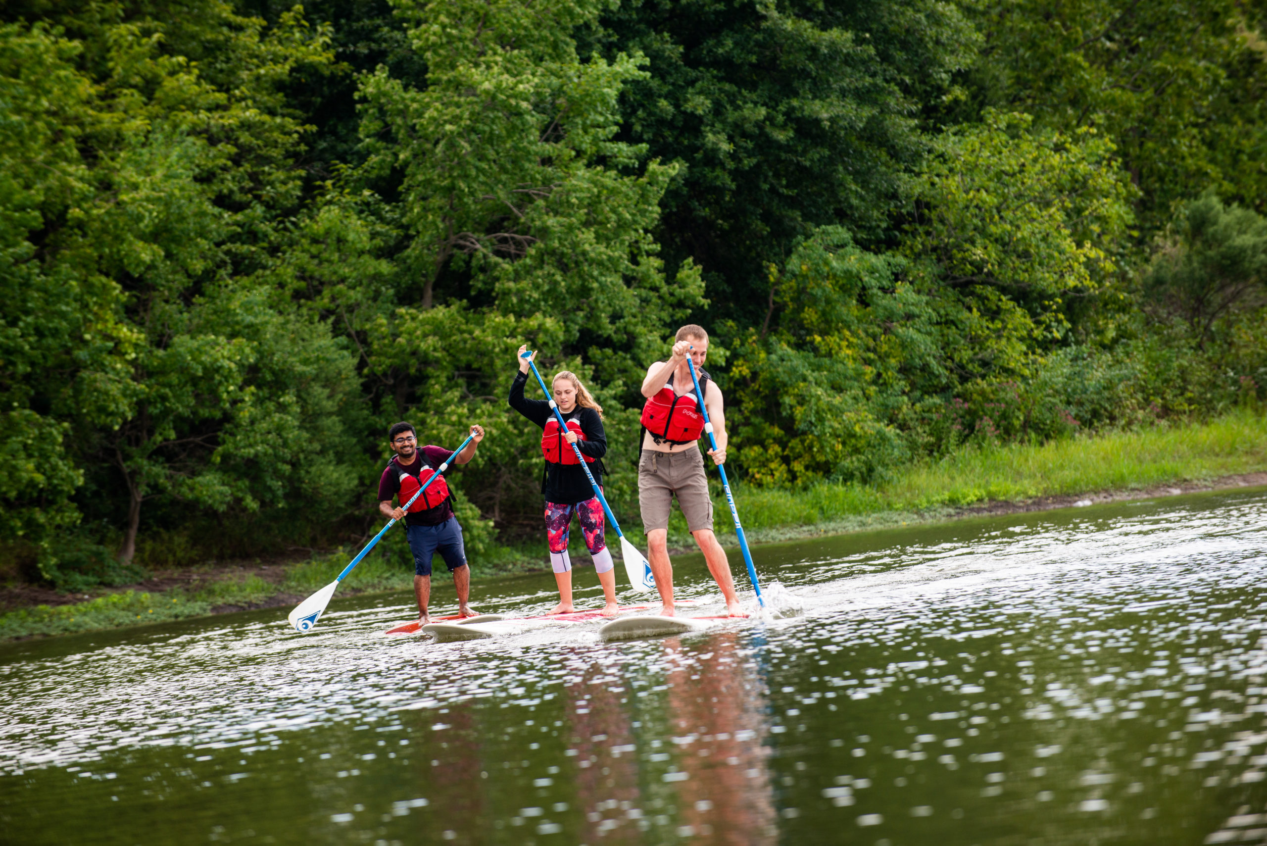 Students paddle boarding