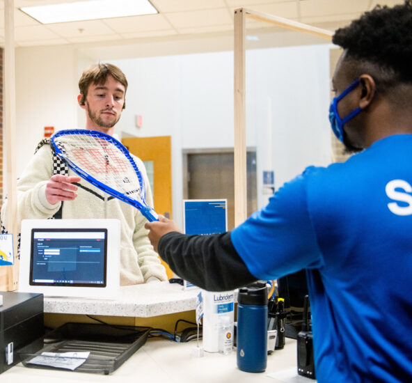 TAMUC student being helped by Campus Recreation employee.