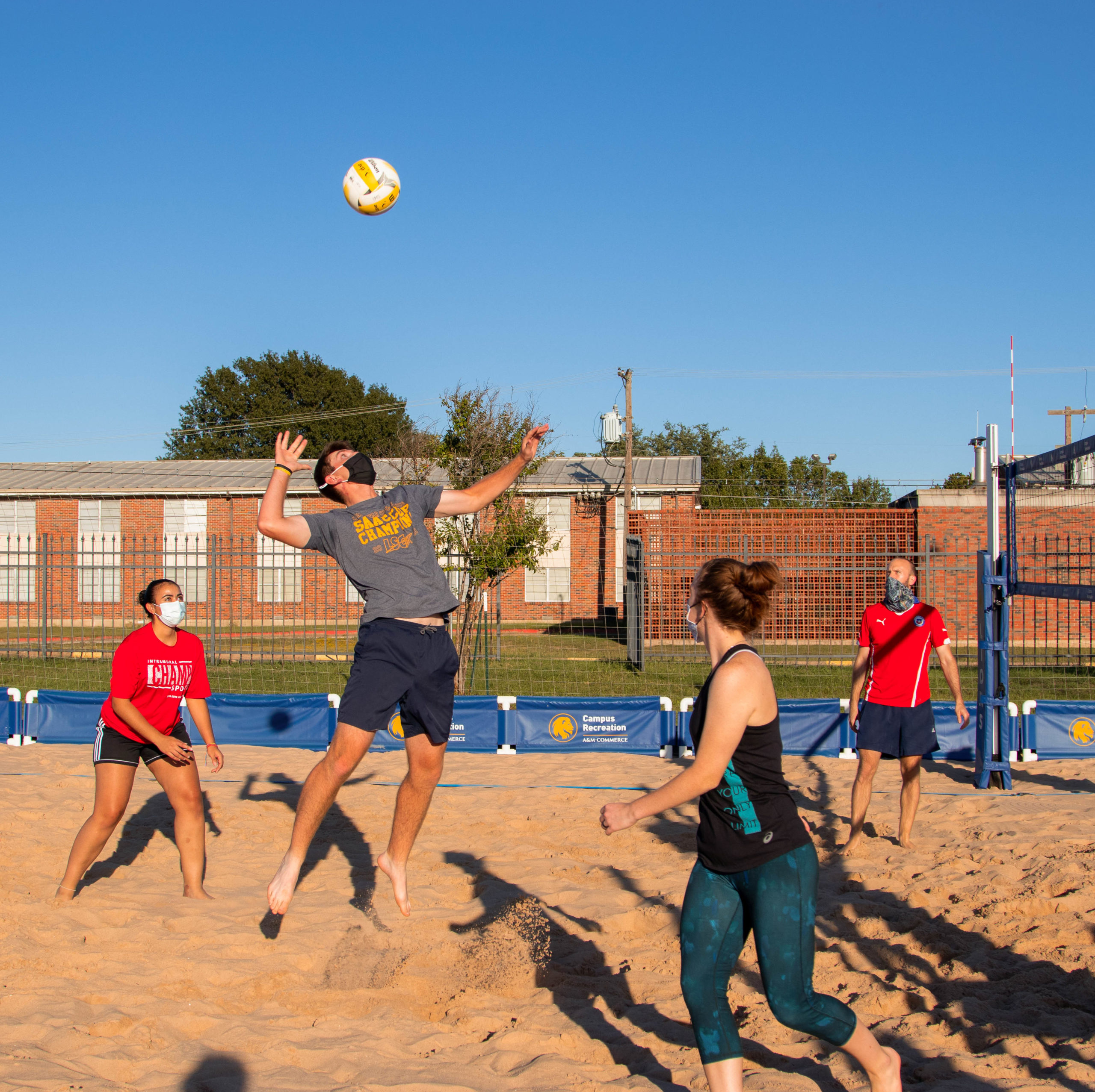 Students playing sand volleyball.