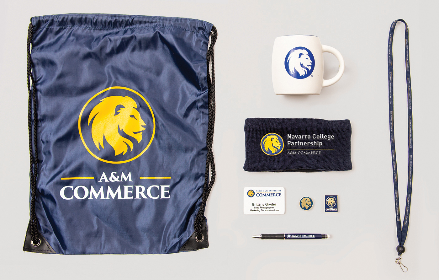 A&M-Commerce merchandise including small bag, coffee mug, pens.