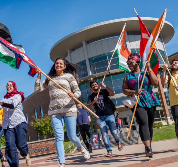 International Students carrying their flags.