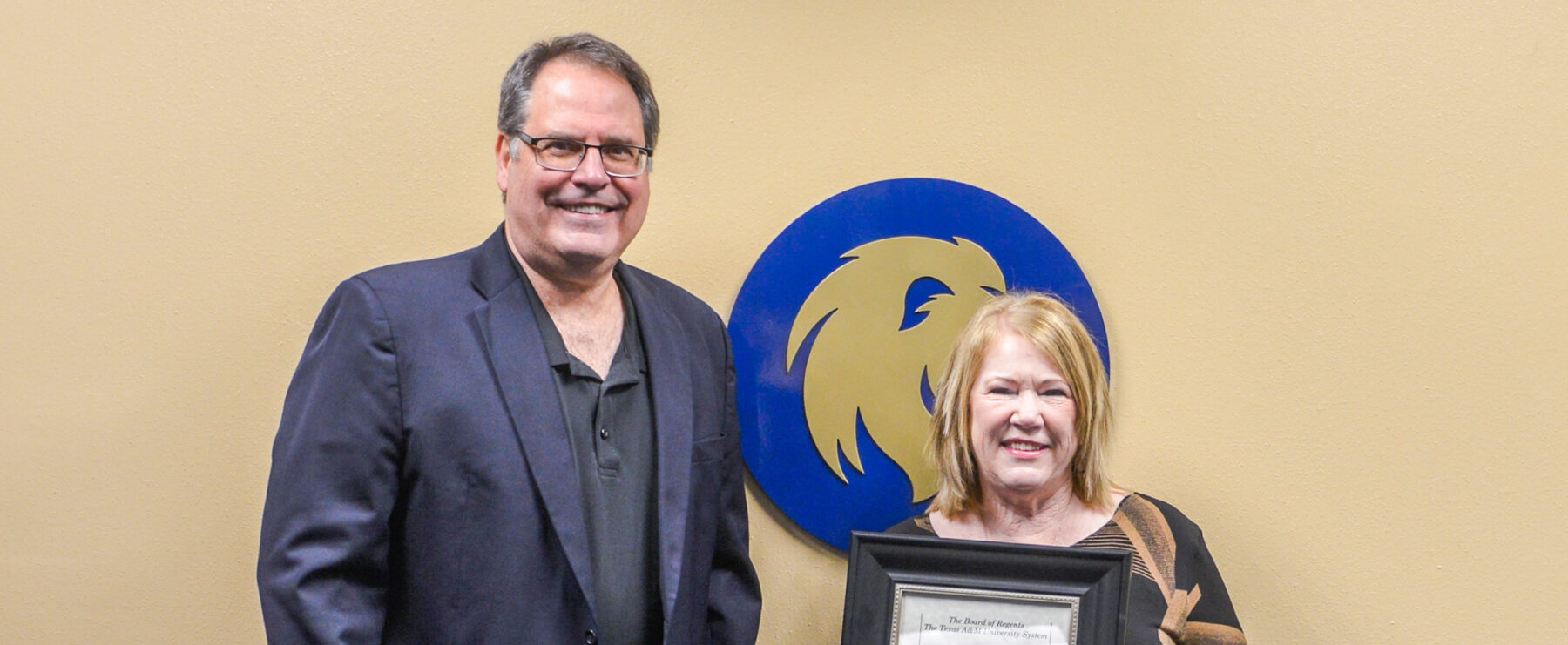 Alicia Currin receives am Emeritus honor from the A&M System, presented by Dr. Mark Rudin