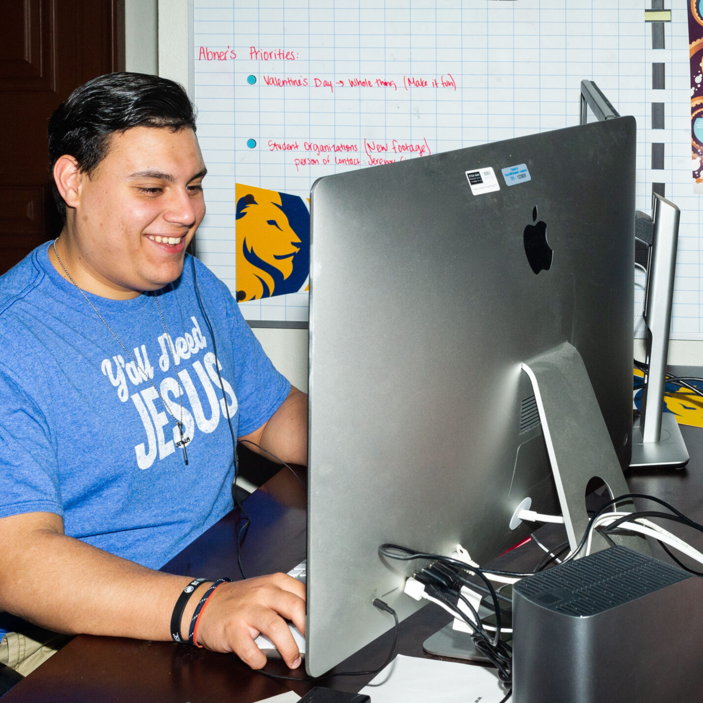 Photo with bad lighting of a student in front of computer.