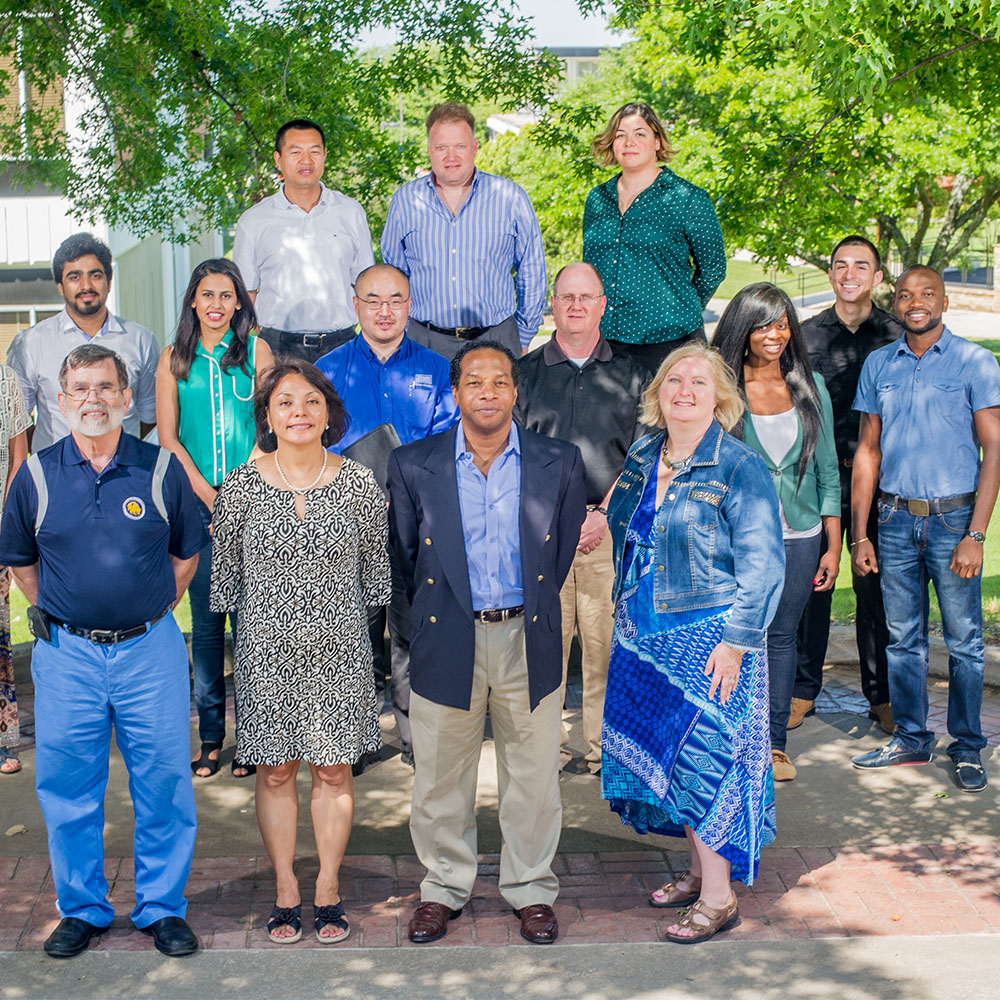 Photo of a group of students and professors with bad lighting.