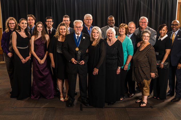 Student and faculty receiving an award.