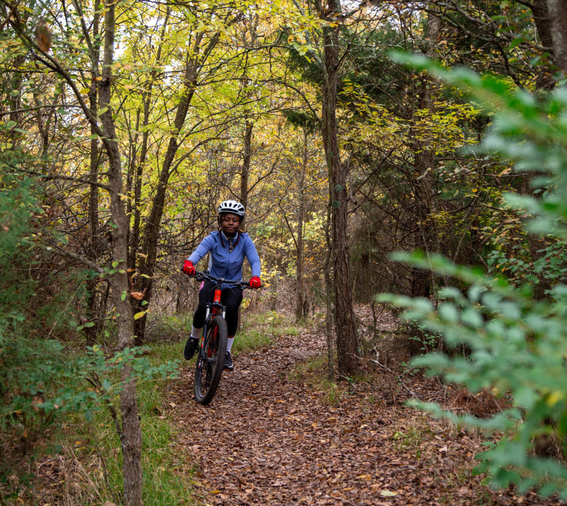 Student on a bike at the Outdoor Adventure bike trail. 