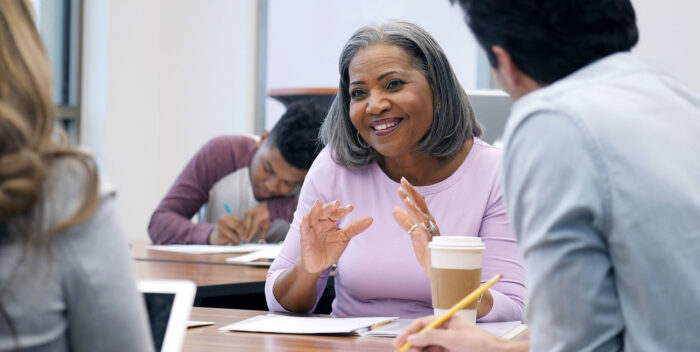 Cheerful adult student participates in study group.