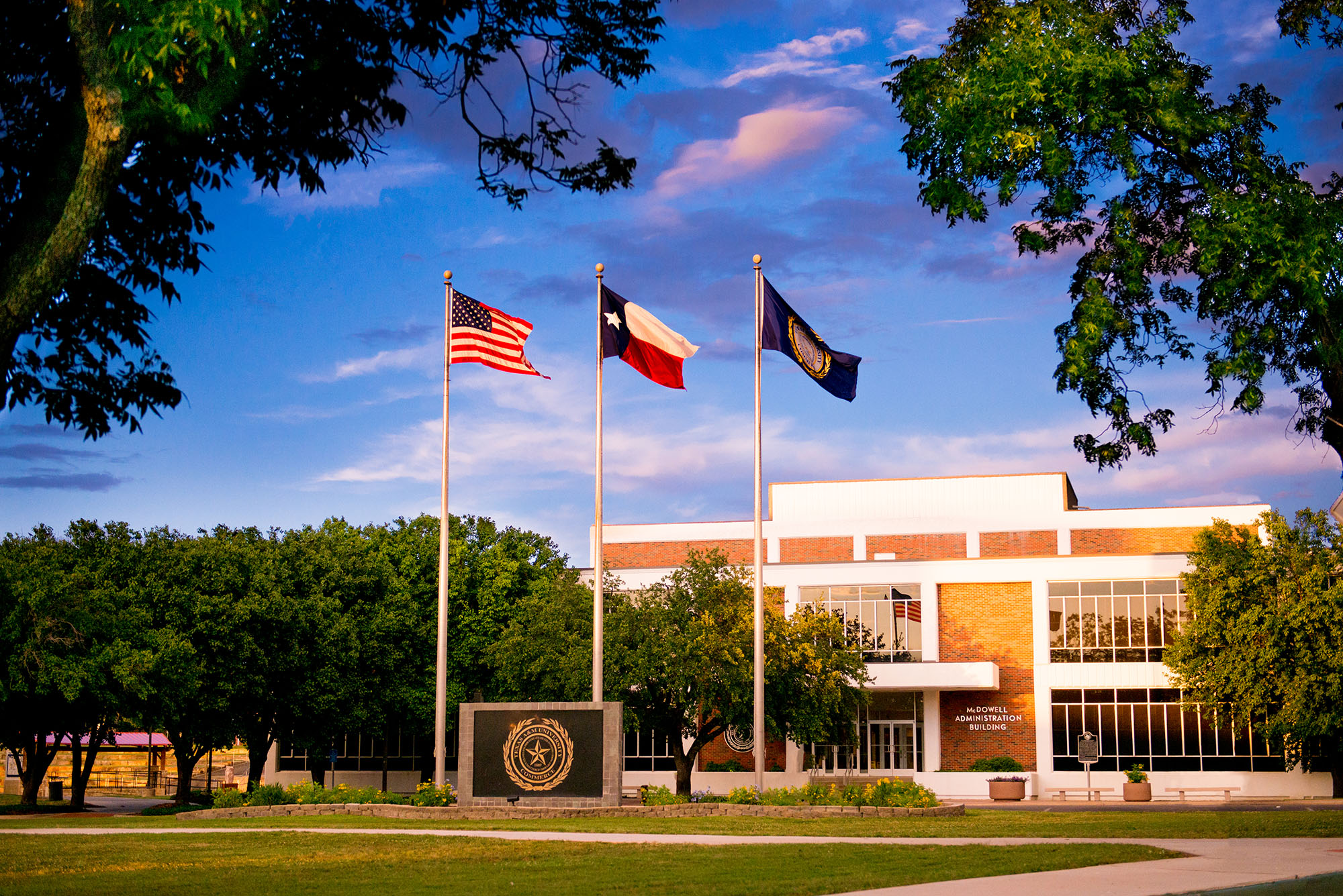 The business building with three flags in front of it.