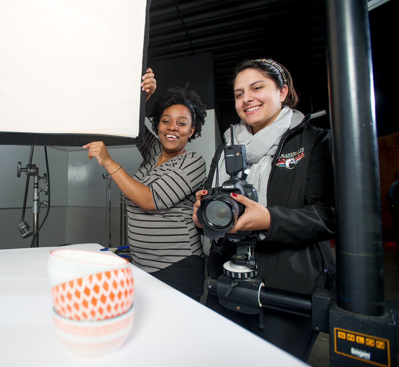 Two female students working together on a photography project.