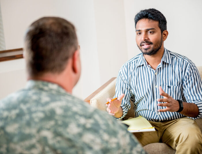 Social worker talking to man in the military.