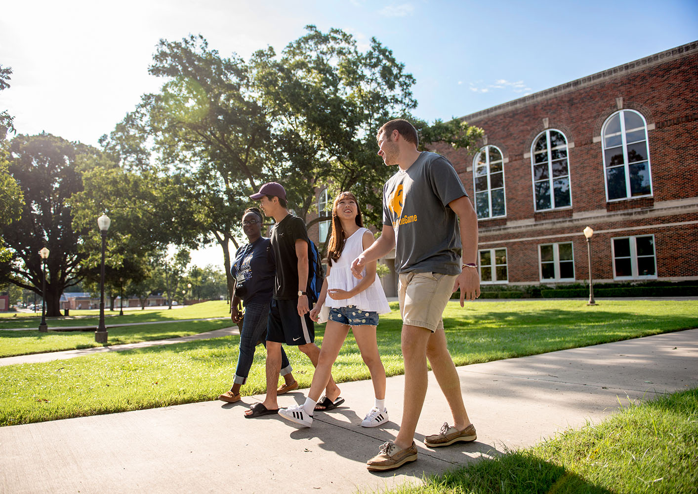 Four students walking on the A&M-Commerce campus.