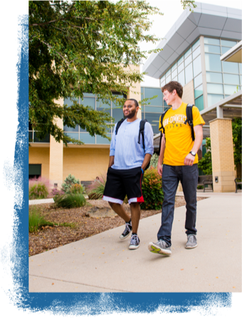 Two student walking on campus.