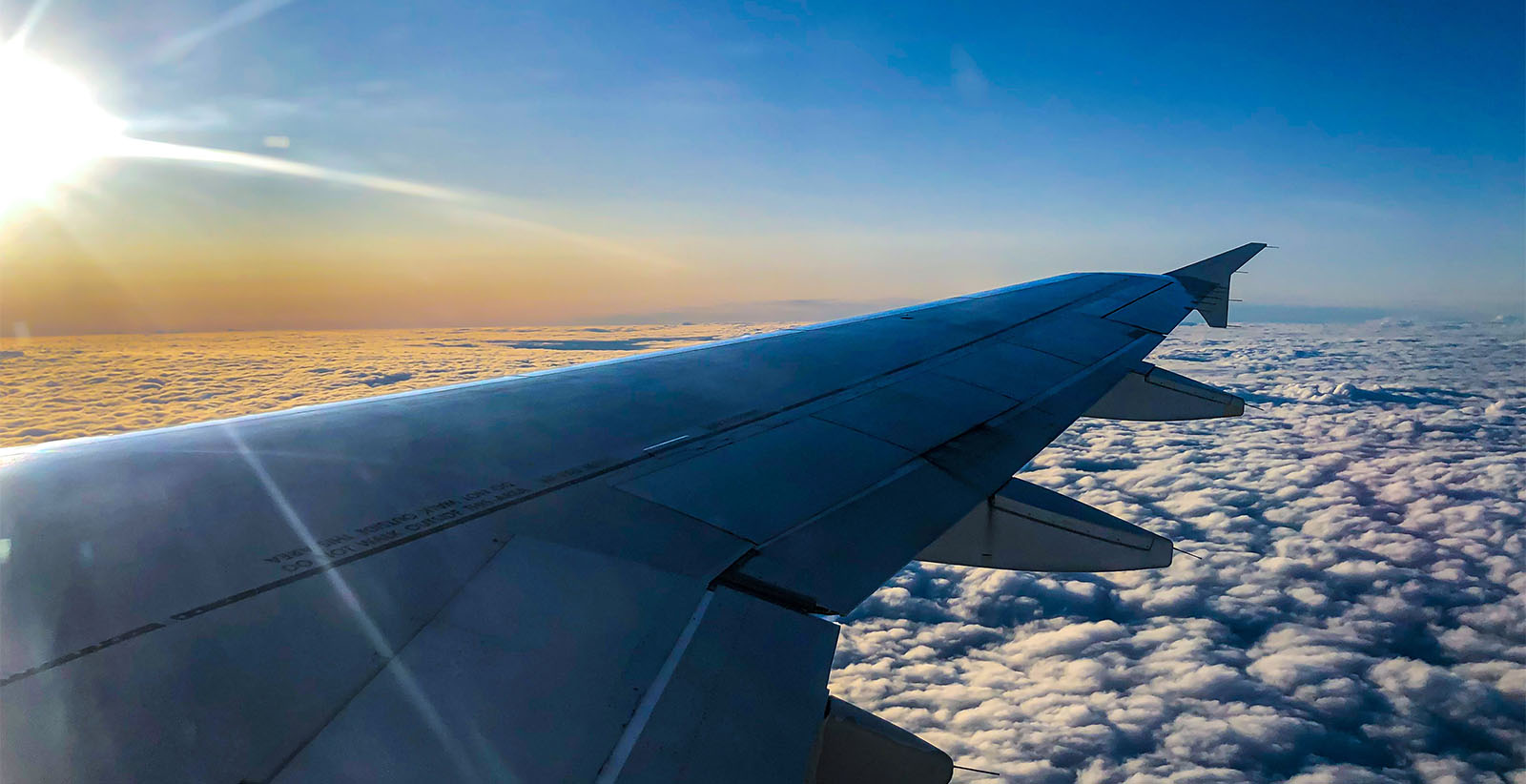 Plane wing in the clouds.