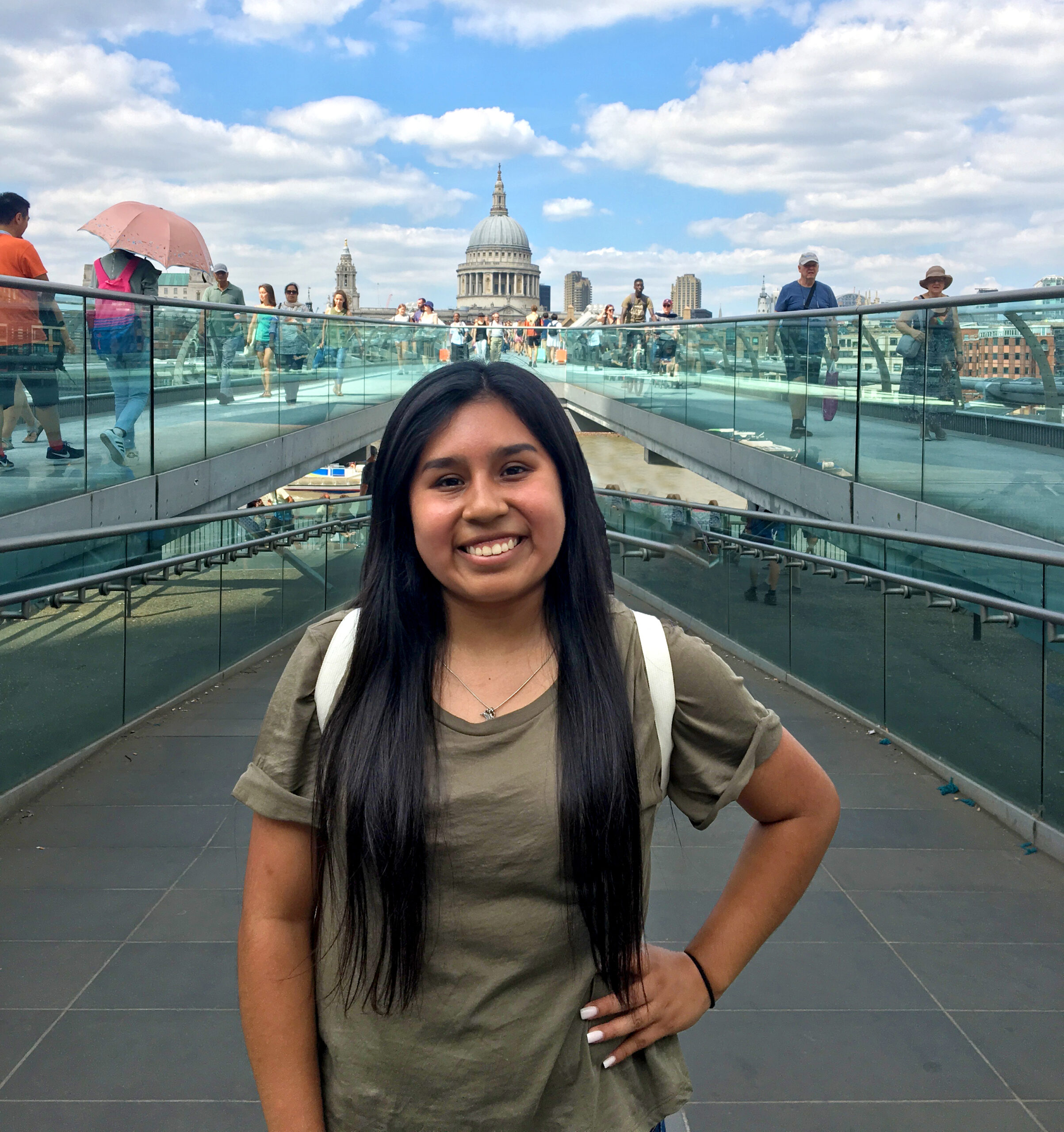 A female student in front of a dual stair case