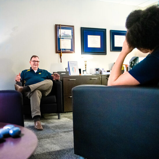 Two people chatting in a comfortable room.