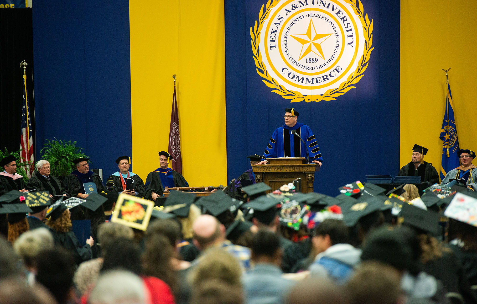 The president of the university making an announcement during graduation.