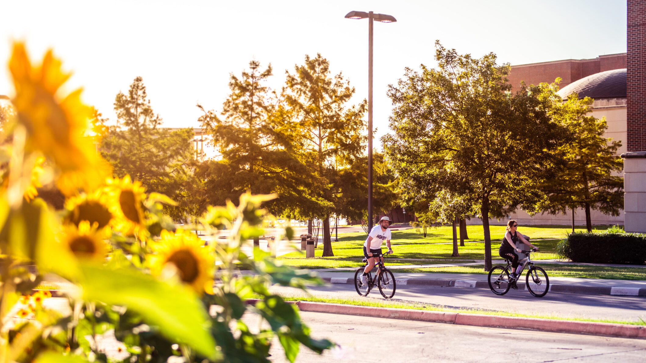 A picture of students riding a bike on campus