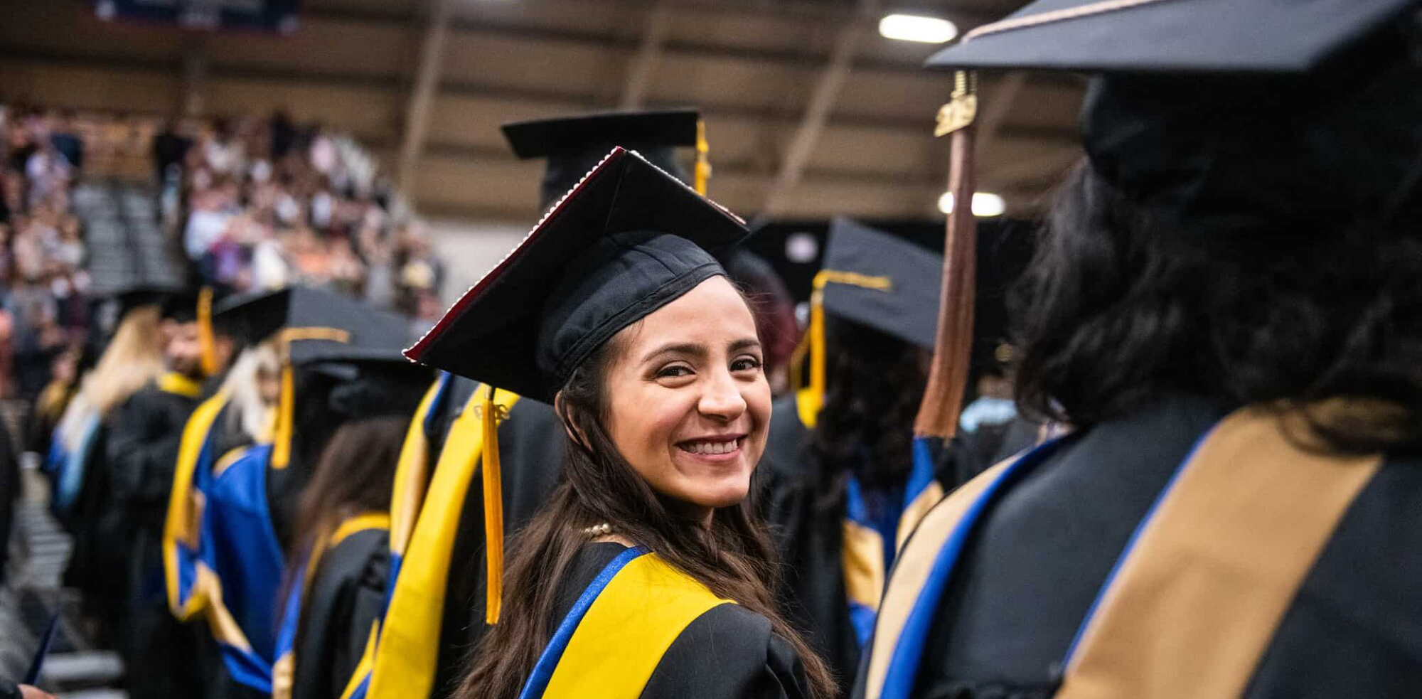 A latin female smiling while at her graduating ceremony