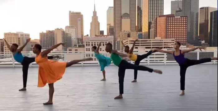 group of dancers with city scape behind them