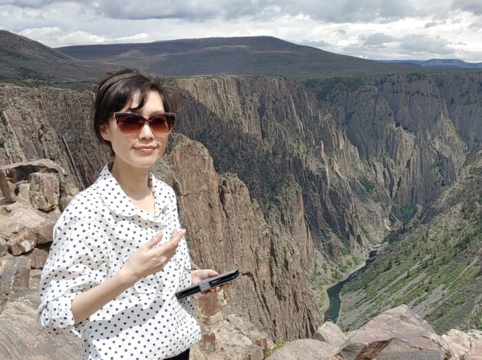 Hyunjung Lee on top of a mountain.