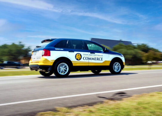 University car with logo and Texas A&M University-Commerce on the side.