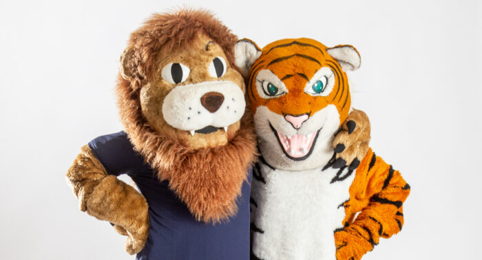 A&M-Commerce lion mascot with a tiger mascot.