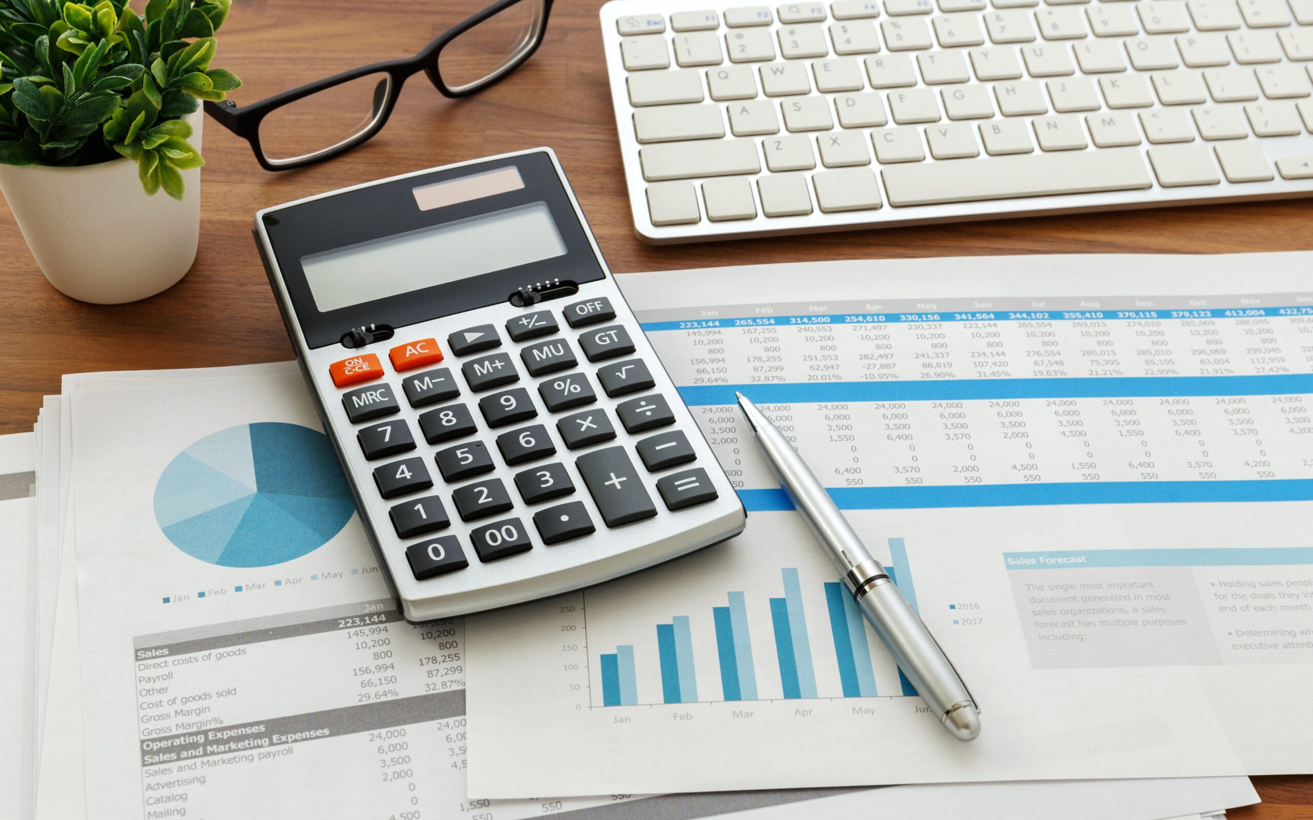 Financial accounting with calculator and financial chart data and computer keyboard