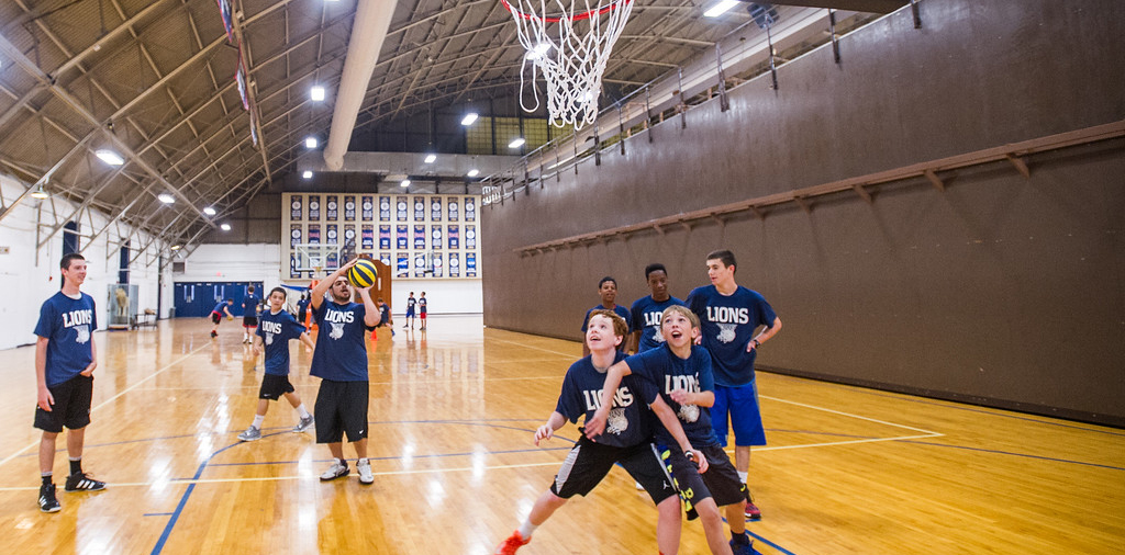 Youth team in the field house playing basketball.