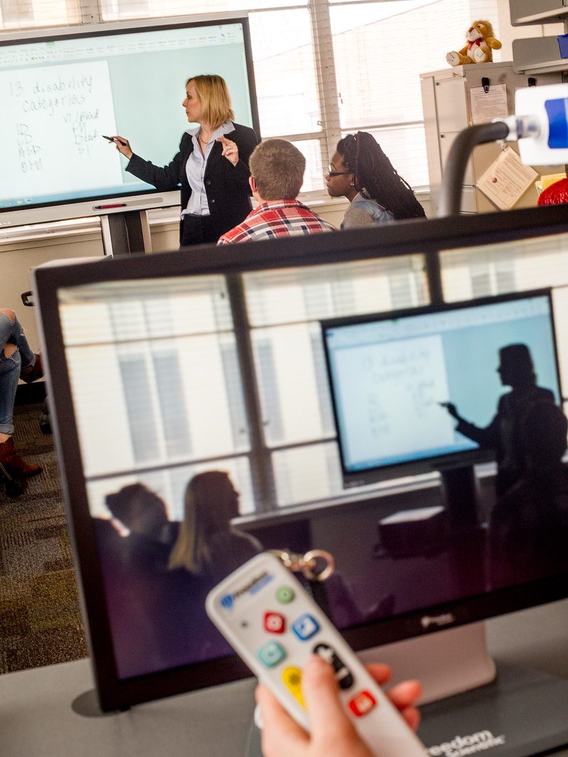 Professor presenting assistive technologies in a class.