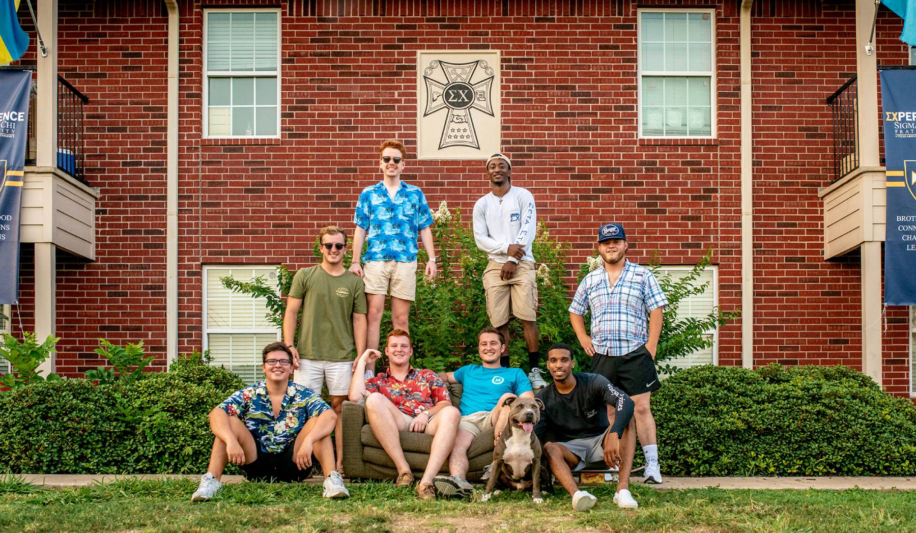 Group of members in front of Sigma Chi house.