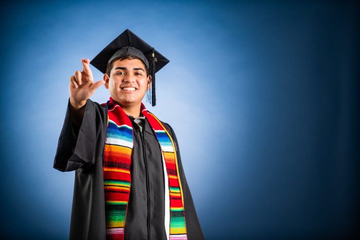 A TAMUC graduate flashes the "L" hand sign to signify Lions