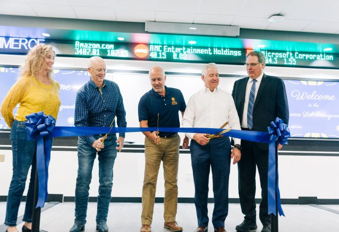 5 Individuals cutting a ribbon