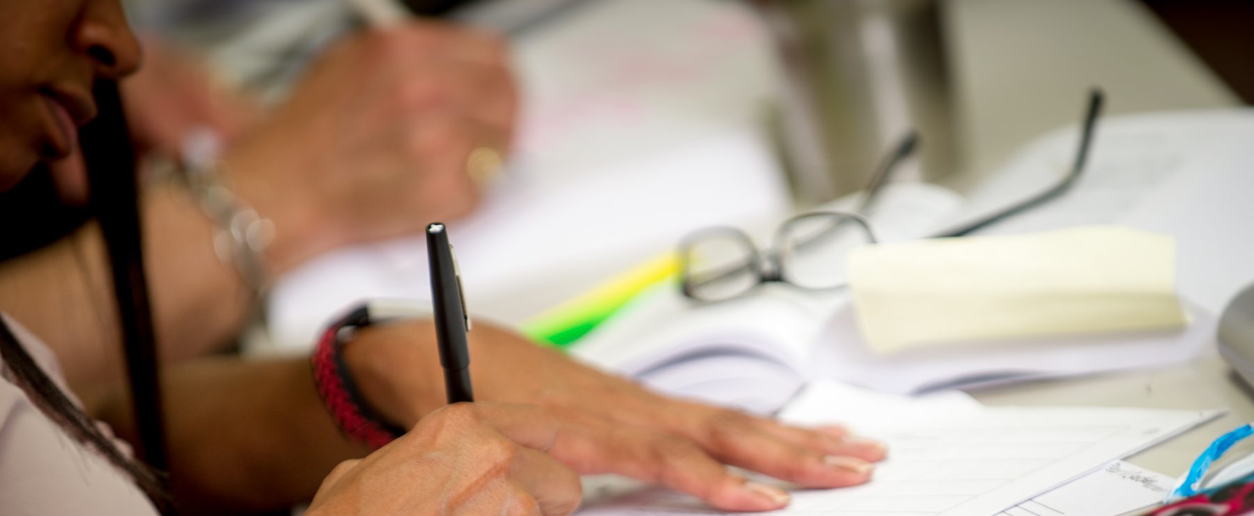 Person writing at a desk