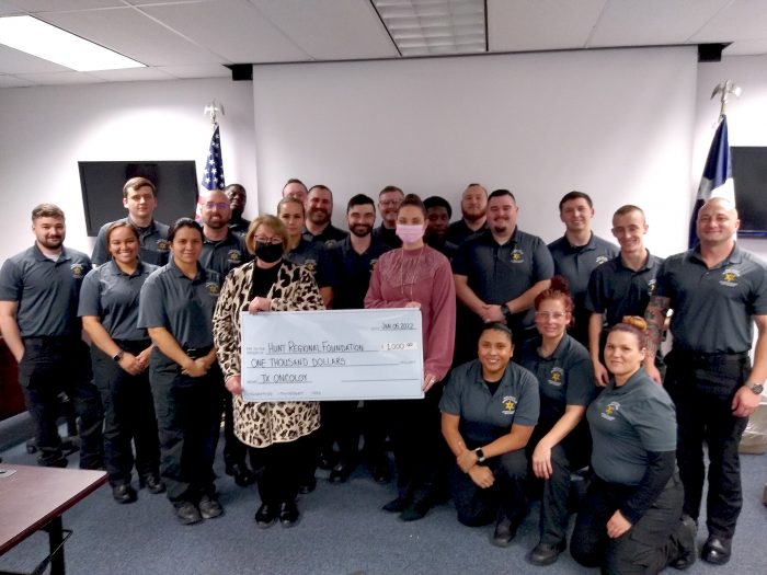 Cadets present a check to Texas Oncology