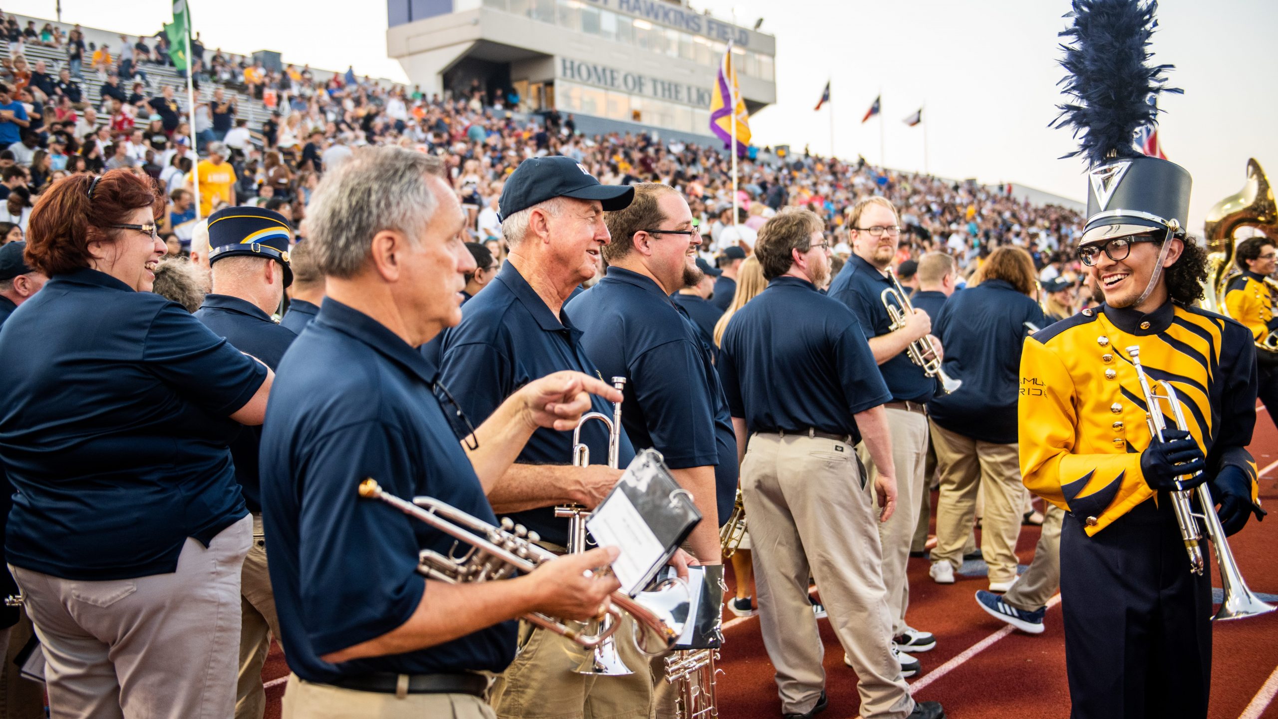 A group of individual playing instruments at the stadium.