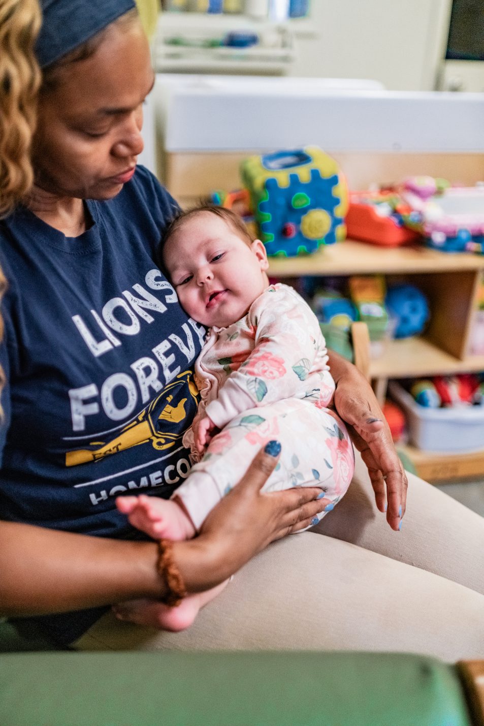 attentive employee holding a sleeping baby.