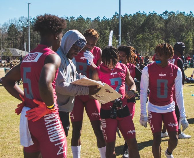 CJ Cannon discusses a play during a timeout with his players