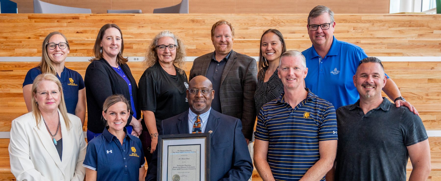 faculty members pose for a photo with Dr. Henry Ross