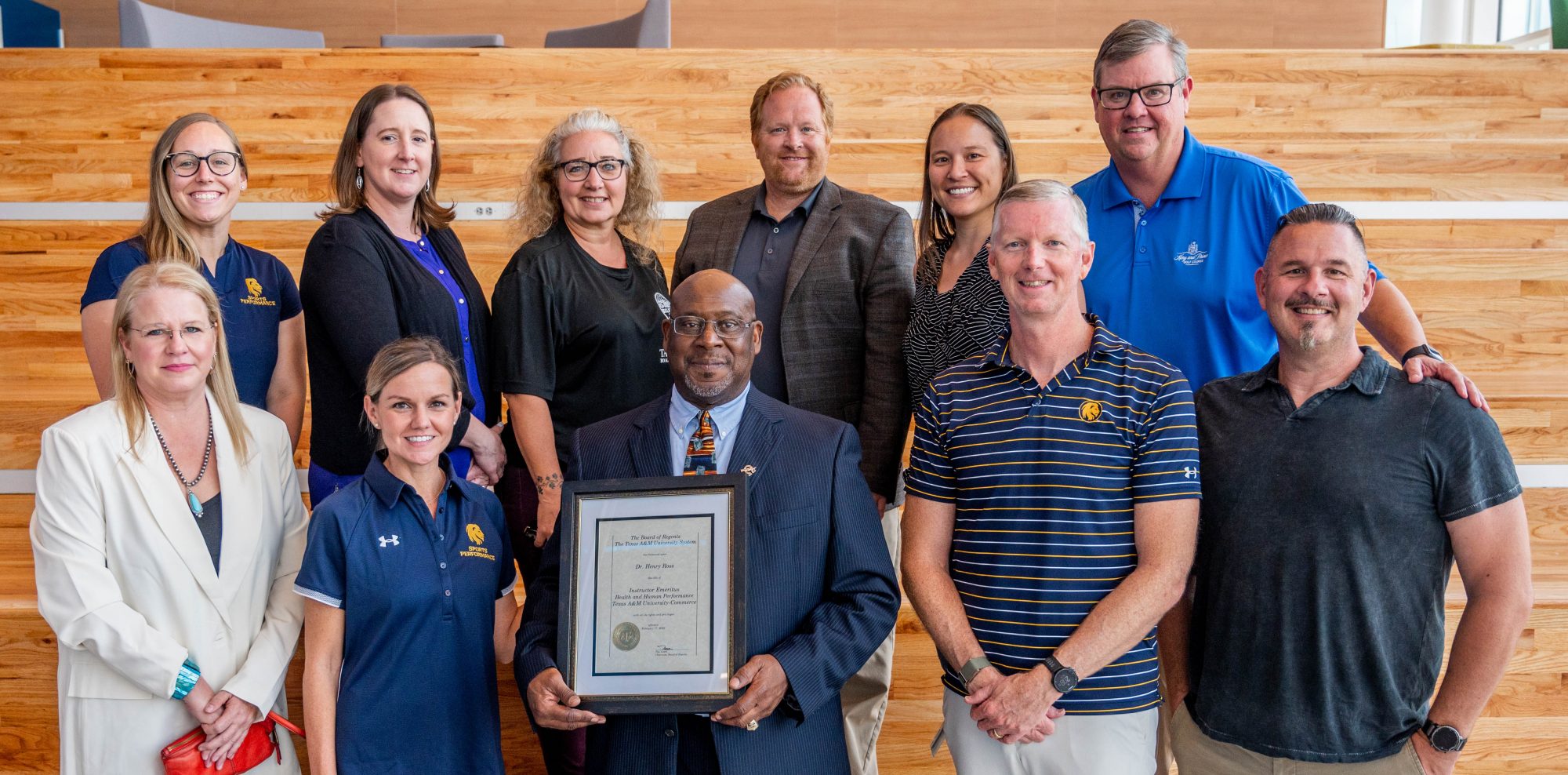 faculty members pose for a photo with Dr. Henry Ross