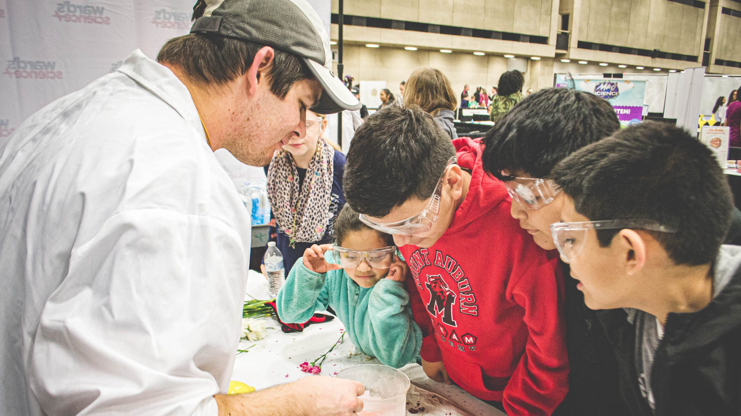 Students engaged in a science experiment that is being instructed by the instructor.