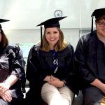 Three A&M-Commerce students pose for photo in caps and gowns