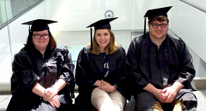Three A&M-Commerce students pose for photo in caps and gowns