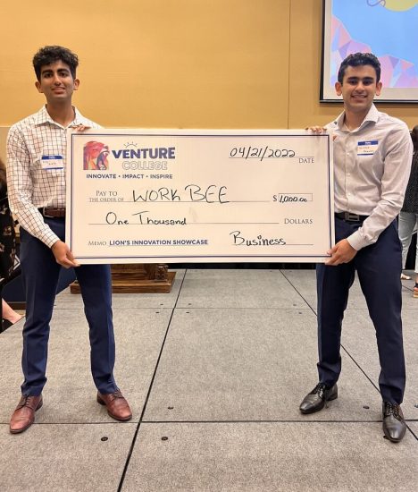 Two Students receiving a large check award