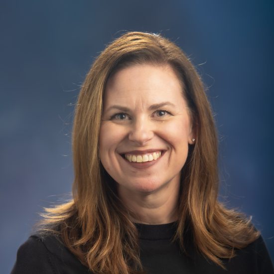 Headshot of Kathryn Dixon, a woman with white skin and long red hair.