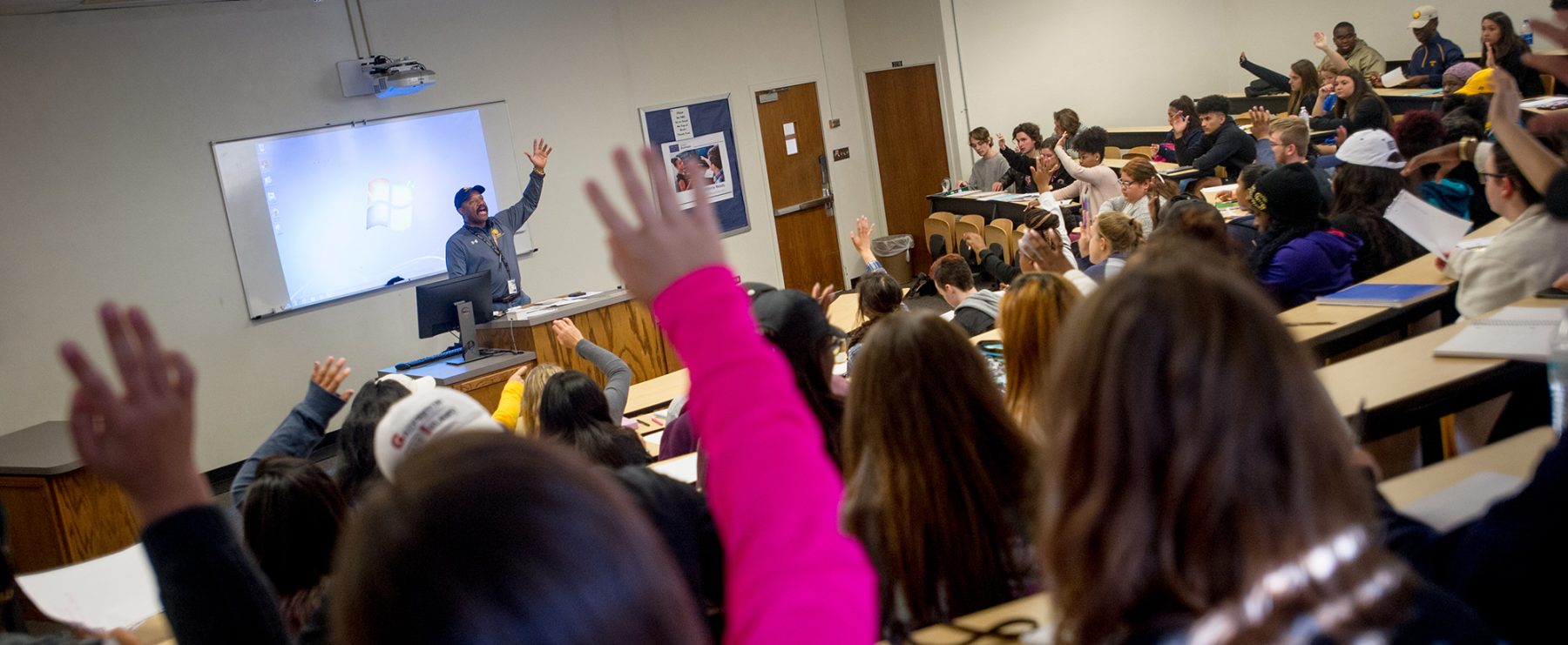 A professor interacts with the classroom